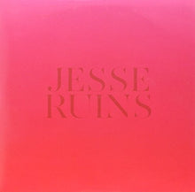 the album cover for Ruins, Jesse - A Bookshelf Sinks Into The Sand
