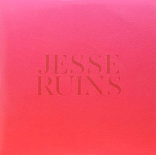 the album cover for Ruins, Jesse - A Bookshelf Sinks Into The Sand