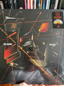 the album cover for Rise Against - Ricochet [Colored Vinyl] [Clear Vinyl] [Limited Edition] (Org) (Ita)