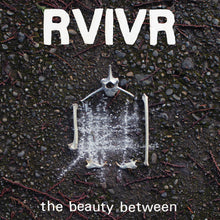 the album cover for RVIVR - The Beauty Between [Black/Clear]